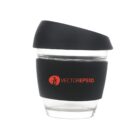 A transparent glass cup with a black silicone band around the middle, featuring the text VECTOREPS10 in red. The cup has a black lid with a slanted top.