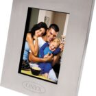 A family photo in a silver frame with the word Onyx at the bottom. The image shows a woman, a man, and a child sitting together, smiling and embracing each other warmly.