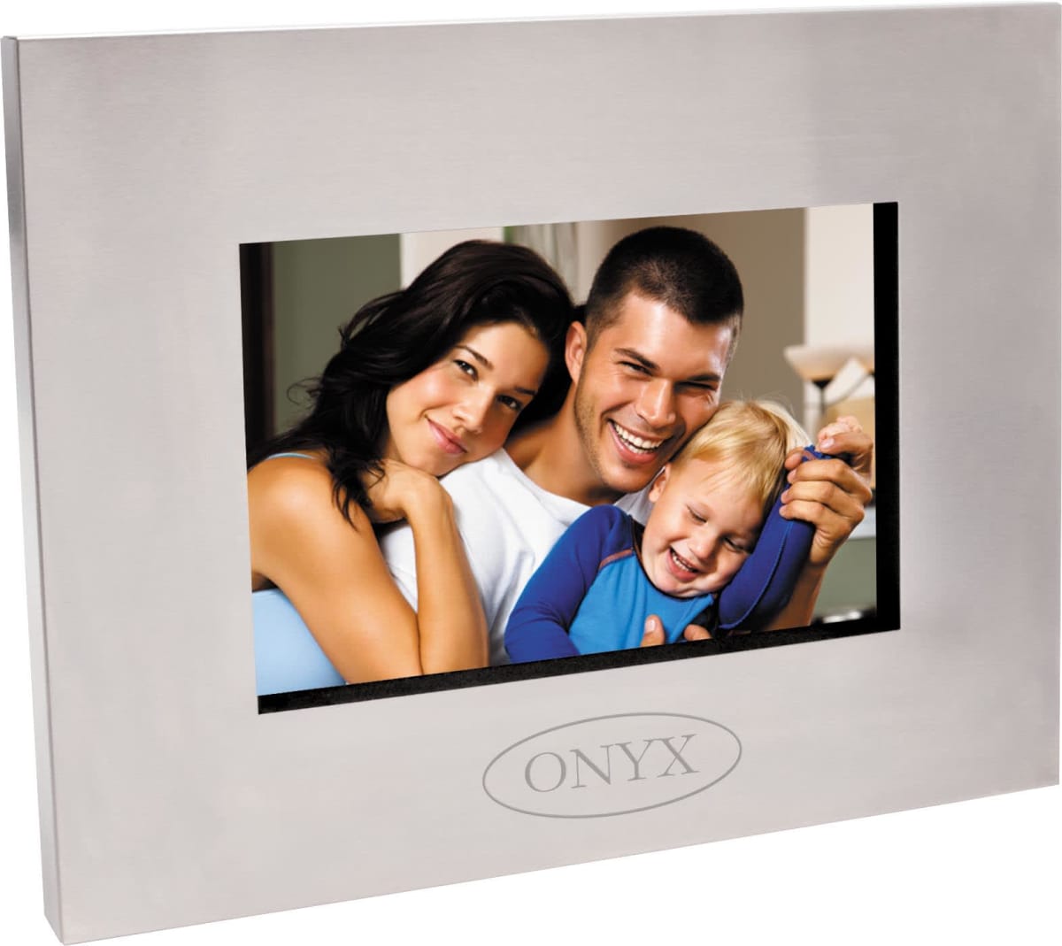A framed photo of a smiling family with a man, woman, and young boy. The frame is silver and labeled ONYX. The man is holding the boy, and the woman is leaning on the mans shoulder, all appearing happy and relaxed.