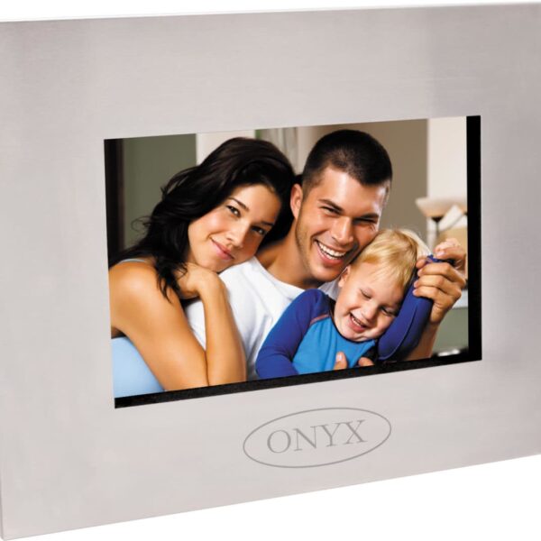 A framed photo features a happy family of three: a woman, a man, and a young child. They are smiling and closely embracing. The frame has a sleek, silver design with the word ONYX engraved at the bottom.