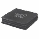 Four stacked black slate coasters with the text TIME ZONE and a sun logo printed on the top one.