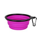 Collapsible pink silicone pet bowl with a black rim and a carabiner attached.