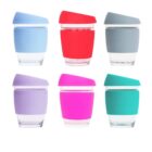 Six reusable cups with silicone lids and grips in blue, red, gray, lavender, pink, and teal, arranged in two rows on a white background.