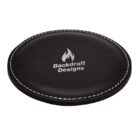 A round, black leather coaster with white stitching around the edge. It features a flame logo and the text Backdraft Designs in white on the top surface.