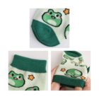 Close-up of green ankle socks with a cartoon frog design that features pink cheeks and orange stars. There are three images: one showing the top view, another displaying the ribbed ankle cuff, and the last showing the sock being stretched.
