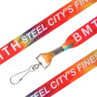 A vibrant red and multicolored lanyard with the text STEEL CITYS FINEST and BMTH in white. It features a metal clip for attachment at the end.