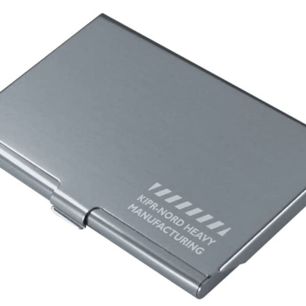 A sleek, silver metal case with the text KIRNORD HEAVY MANUFACTURING and a geometric pattern printed on the surface. The case is closed and has a hinge on one side.