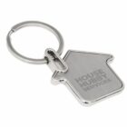 A silver keychain shaped like a house with the engraving HOUSE HUBBY SERVICES on its surface. The keyring is attached at the top corner of the house shape.