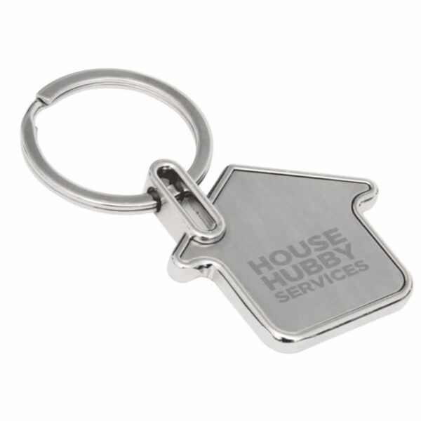 A metal keychain shaped like a house, with the words HOUSE HUBBY SERVICES engraved on it. The keychain has a silver finish and is attached to a circular key ring.