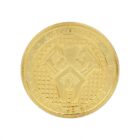 A gold coin featuring a geometric pattern in the center, resembling a stylized animal face. The coins surface has a textured grid and embossed inscriptions along the edges.