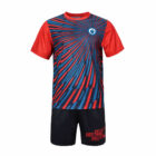 A sports outfit featuring a red and blue abstract design. The short-sleeved shirt is predominantly red with a dynamic pattern of blue lines radiating from the chest. The black shorts have red text at the hem.