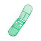 A green pill splitter with a transparent body is shown open. The splitter contains a compartment for the pill and a small blade for cutting.
