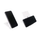 Two smartphones positioned on a white wireless charging stand. One phone is placed vertically while the other is horizontal, demonstrating the stands adjustable feature. The stand has a simple, modern design.