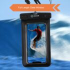 A smartphone in a waterproof case displays a photo of a person surfing on a wave. The case has a clear window and is surrounded by the image of an ocean wave in the background. Orange arrow points to text: Full Length Clear Window.