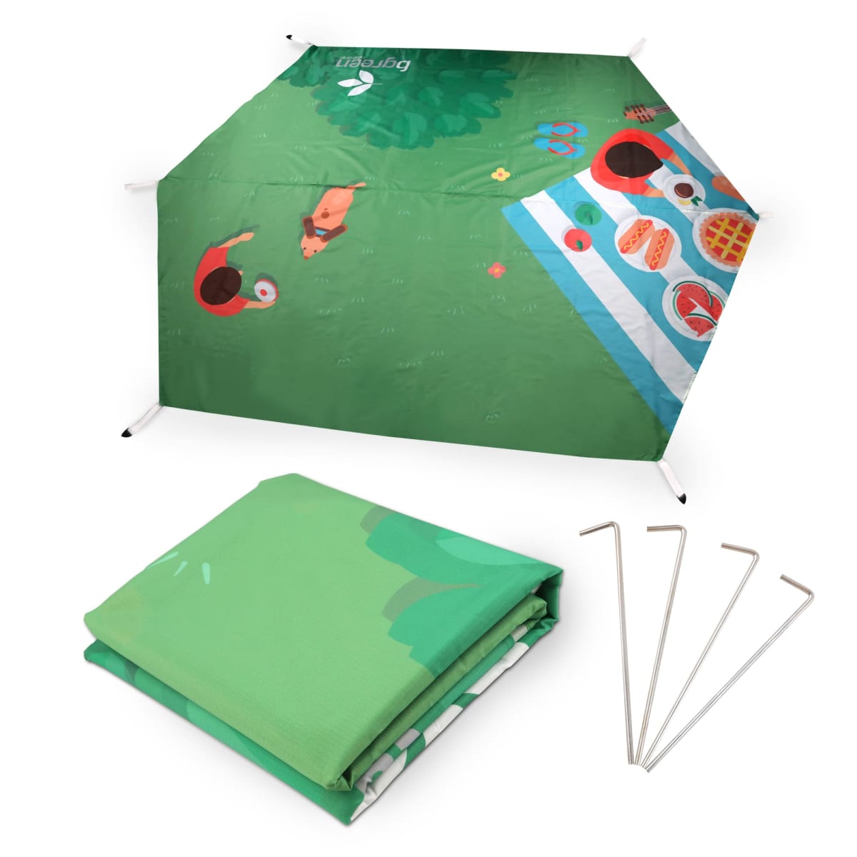 A green picnic blanket with a colorful design, depicting a top-down view of two people at a picnic, food items, and a nearby tree. The blanket is shown folded alongside four metal stakes for securing it.
