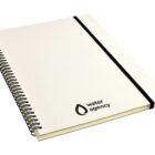 A spiral-bound notebook with a beige cover. The black logo and text on the front read water agency. A black elastic band is attached to the right edge for securing the notebook.