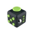 A black fidget cube with green accents, featuring various tactile elements including buttons, a dial, and a ball bearing. Designed for stress relief and focus enhancement through different sensory interactions.