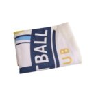 A folded white fabric with part of the text BALL CLUB in blue and yellow, along with some blue and yellow stripes.
