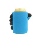 A hand wearing a black glove holds a beverage can wrapped in a bright blue can cooler. The can label is partially visible, revealing that the drink is Crystal Spring Peach Tea.