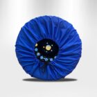 A car wheel covered with a bright blue protective cover, featuring an adjustable drawstring in front. The background is a simple gradient from light to dark gray.