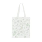 A white tote bag with green line drawings of various fruits, including bananas, apples, grapes, lemons, cherries, and watermelon slices, scattered across the front. The bag has long handles for carrying.