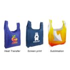 Three reusable bags with different prints: a blue bag with a citrus logo labeled Heat Transfer, a dark blue bag with a polar bear logo labeled Screen print, and a yellow-orange bag with abstract shapes labeled Sublimation.