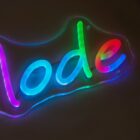 Colorful neon sign displaying the word node with each letter in different hues: blue, green, red, and pink, glowing against a dark background.