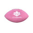A pink American football with a white lotus design and the text LOTUSDESIGN on it. The balls surface texture is visible, and it has white laces on top.