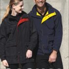 A woman and a man are smiling while wearing casual outdoor jackets. The woman wears a black jacket with a red lining, and the man wears a navy jacket with a yellow lining. The word CASUAL is displayed at the bottom, and BOCINI is at the top left.