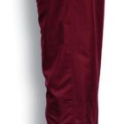 Side view of burgundy-colored pants with an elastic waistband and a zipper at the ankle. The fabric appears smooth and lightweight.