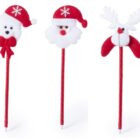 Three festive pens with soft toppers: a bear with a bow, a Santa face, and a reindeer. Each is adorned with red, white, and snowflake details, with red pen bodies.