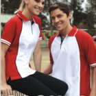 Two people wearing red and white polo shirts with the BOCINI logo pose outdoors. The person on the left is sitting with a smile, while the person on the right stands, also smiling. The word CASUAL is in large letters at the bottom.