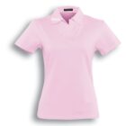 A light pink short-sleeved polo shirt with a collar, shown on a plain white background. The shirt has a tag inside the collar with text and a shadow cast on the background.