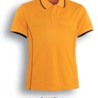 A gold-colored polo shirt with black trim on the collar and sleeve edges. The fabric appears smooth, with structured stitching along the sides. The shirt is displayed on a plain white background with a shadow effect.