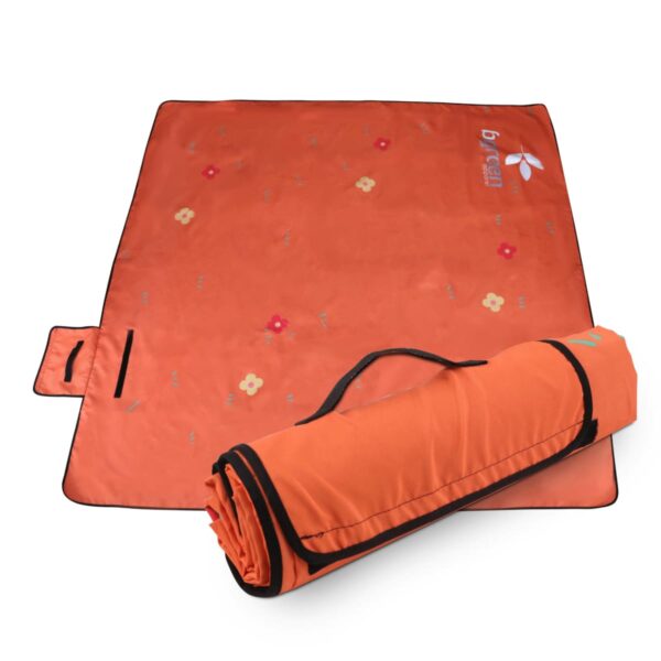 Orange outdoor picnic mat with small floral patterns, displayed both laid out flat and rolled up. The mat features a handle and strap for easy carrying.