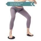 Person in gray leggings performing an exercise using two circular sliders placed under their feet, with knees bent. Text reads, Developing the whole body coordination. White background.