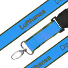 Blue lanyard with Lufthansa printed in black text. It features a black plastic clip and a metal hook attachment.