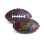 Two American footballs with colorful, multicolored camouflage patterns. The balls have a textured surface and white laces, placed on a plain white background.