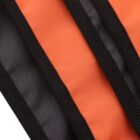 Close-up of a fabric with alternating orange and black stripes. The fabric has a textured, durable appearance, with visible stitching along the edges of the stripes.