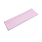 A folded pink cloth lies on a white background. The cloth is rectangular and neatly arranged, showing a smooth and even surface.