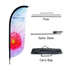 Image showing components of a feather flag set. Includes a flower-patterned flag with text Feather Flag, a pole, a spike base, and a black carry bag.