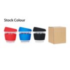 Three reusable coffee cups in red, blue, and black with transparent bands are aligned next to each other. A cardboard box is placed beside them on the right. The text Stock Colour is above the cups.