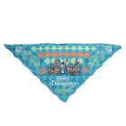 A triangular bandana with a checkered blue and orange pattern. It features cartoon characters in pilgrim attire and the words Happy Thanksgiving at the bottom, decorated with floral designs on the sides.
