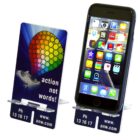 Two mobile phone stands display smartphones with colorful app icons on the screens. The stands feature a rainbow-colored parachute graphic and the text action not words! along with a website and phone number.