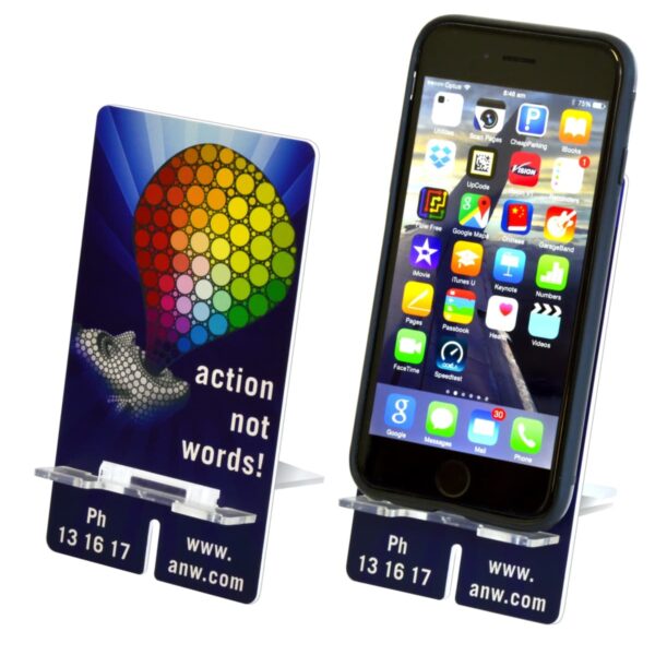 Two phone stands display a smartphone. One shows the front view with colorful app icons; the other shows a side angle. The stands have a rainbow balloon design and the text action not words! along with a website and phone number at the bottom.