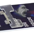 Close-up of a pH test strip with a colorful, circular gradient design. Features the phrase action not words and the text pH 13 16 17 at the side. The website www.anw.com is printed at the bottom left.
