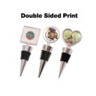 Three wine bottle stoppers with distinct tops: one square with a colorful design, one round with a vineyard image, and one heart-shaped with a scenic illustration. The text Double Sided Print is at the top.