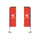 Two red banners with the white logo and text Tele Atlas are displayed on black stands. The design features a stylized figure with an outstretched arm. The banners are positioned against a plain white background.