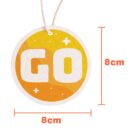 A round, orange hanging tag with the word GO in large white letters. The tag is 8 cm in diameter, with a simple star-like design. A beige string is attached at the top.