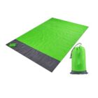 Bright green picnic blanket with a dark gray bottom edge, laid flat. Includes a matching green drawstring storage bag positioned upright beside it.